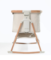 Baby bassinet with wooden frame on a white background

